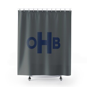 May include: A gray shower curtain with the text "OHB" in navy blue.