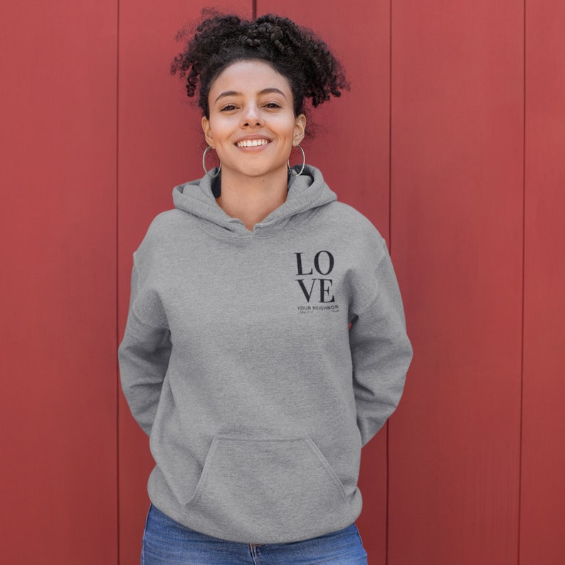 May include: A gray hooded sweatshirt with the words "LOVE YOUR NEIGHBOR" printed on the front.