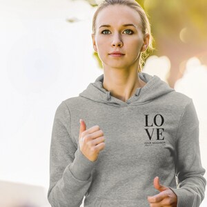 May include: Gray hooded sweatshirt with the text "LOVE YOUR NEIGHBOR" printed on the front.