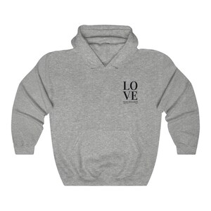 May include: A gray hooded sweatshirt with the text "LOVE YOUR NEIGHBOR" printed on the front.