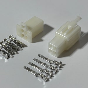 May include: A set of six white electrical connectors with six silver metal pins. The connectors are designed for use with electrical wiring.