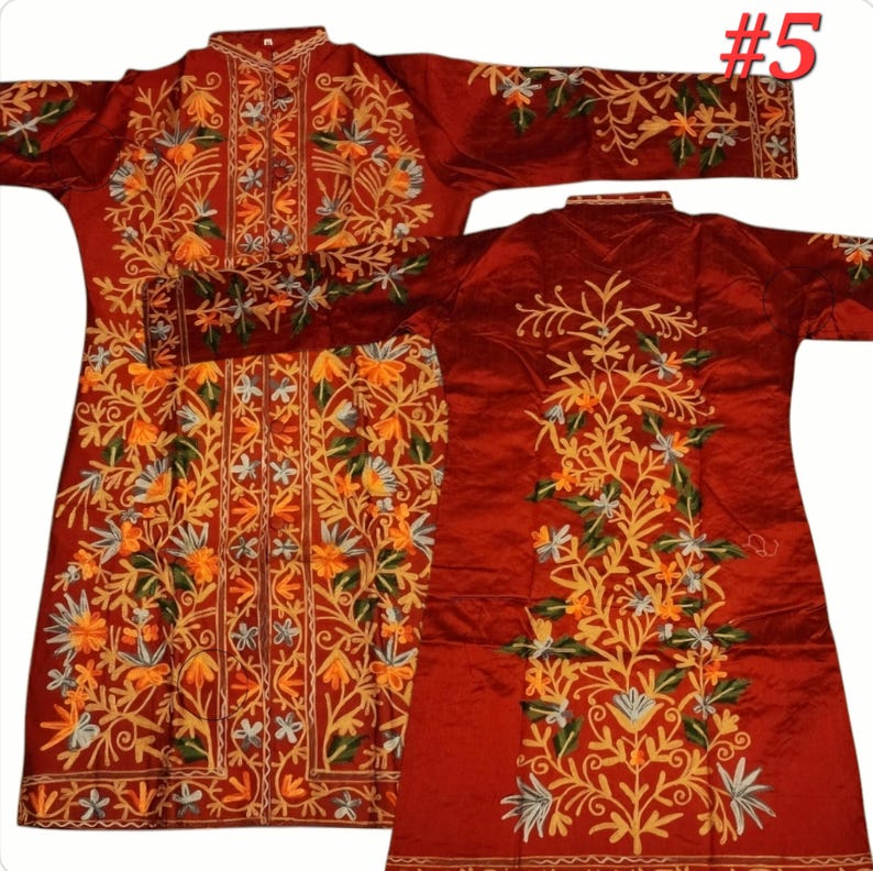 Op de afbeelding: Een bordeauxrood kledingstuk met lange mouwen en ingewikkelde bloemenborduurwerk in tinten geel, oranje, groen en wit. De borduursels bedekken de voorkant, mouwen en achterkant van het kledingstuk. Gepresenteerd op een witte achtergrond.