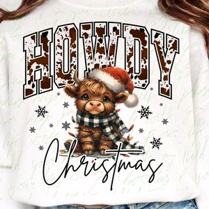 May include: White sweatshirt featuring a brown and white cow print design. The text "Howdy Christmas" is printed in black with a red and white Santa hat on a brown and white highland cow.