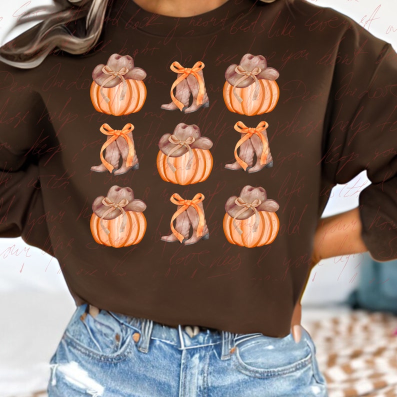May include: Brown sweatshirt with a repeating pattern of orange pumpkins with brown cowboy hats and brown boots with bows.