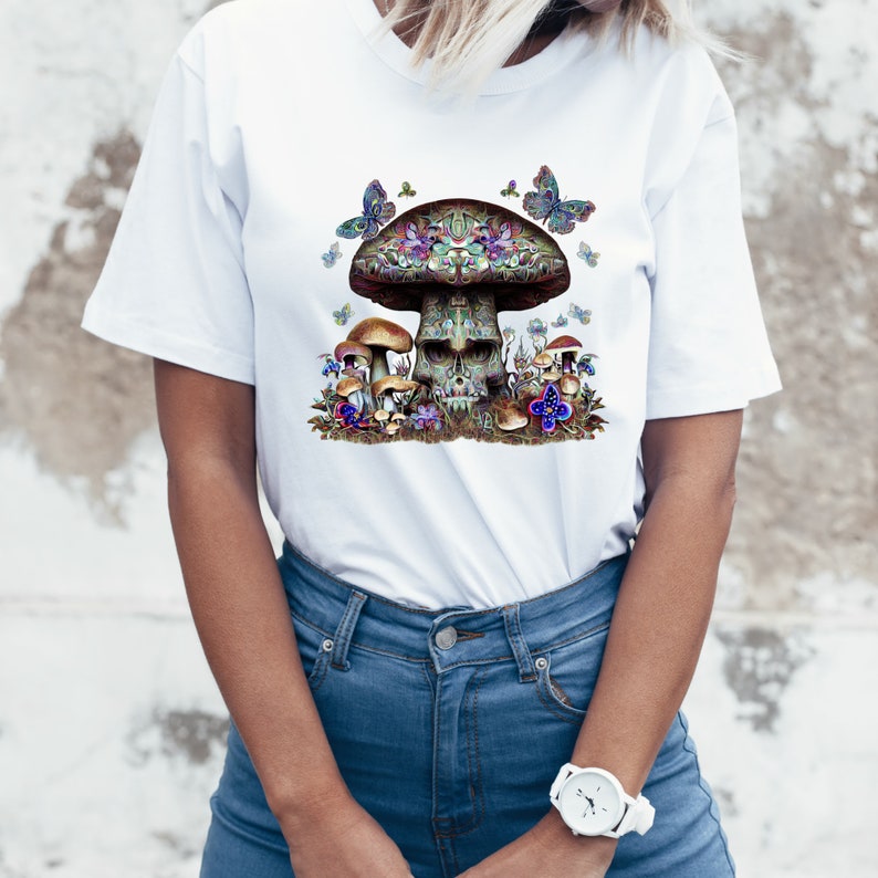May include: White t-shirt with a colorful graphic of a skull mushroom with butterflies and flowers.