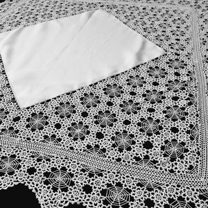 Various white linen tablecloths with lavish crocheted lace