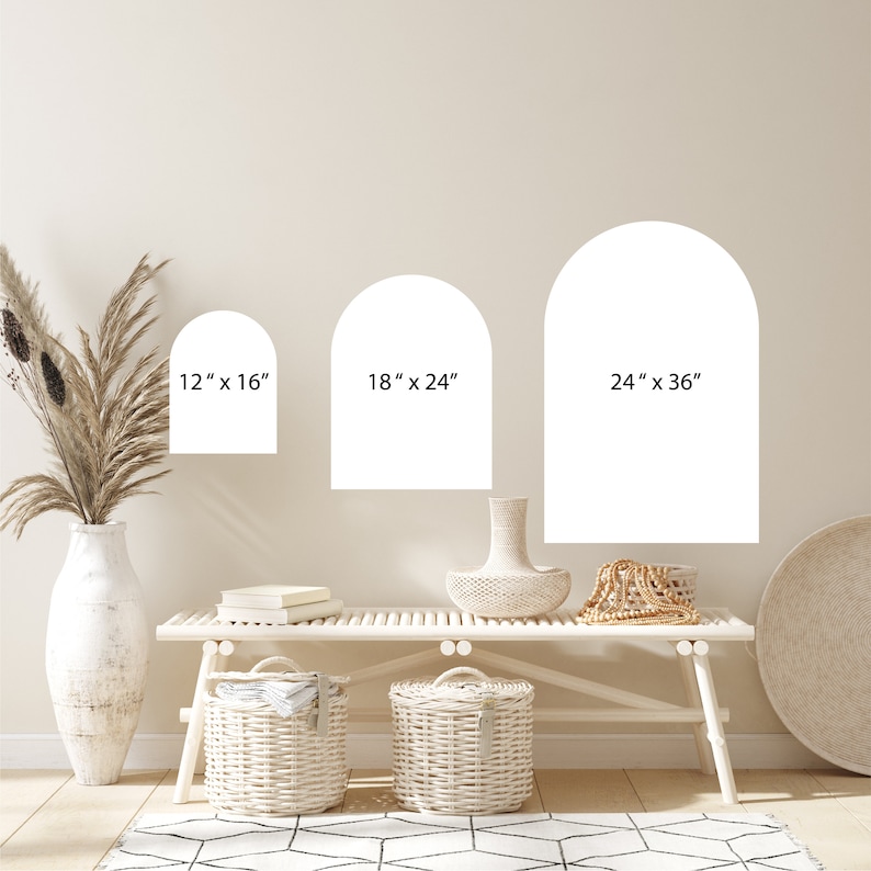 May include: Three white arch-shaped wall decals in different sizes: 12" x 16", 18" x 24", and 24" x 36". The decals are shown on a light beige wall above a white bench with two white wicker baskets.