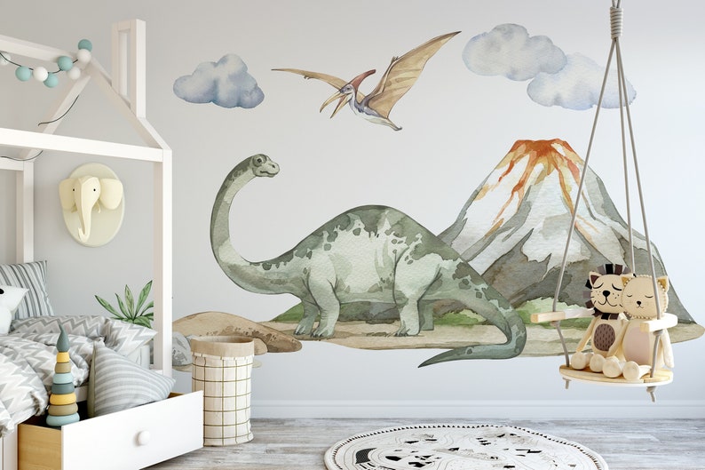 May include: A watercolor-style wall decal set featuring a green dinosaur, a flying dinosaur, a mountain with a red volcano, and two clouds. The decals are perfect for a child's room or playroom.