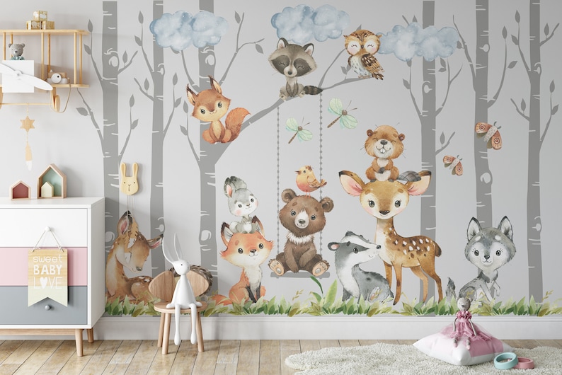 May include: A watercolor mural featuring a gray and white birch forest with various woodland animals, including a fox, deer, bear, raccoon, owl, and wolf. The mural is painted on a light gray background and includes clouds and butterflies.
