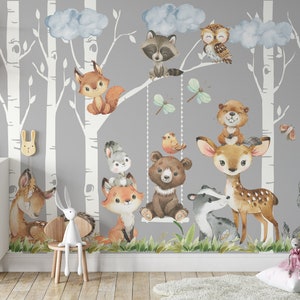 May include: A gray and white woodland nursery wall mural with a variety of animals including a fox, deer, bear, owl, raccoon, and wolf. The mural features birch trees and clouds.