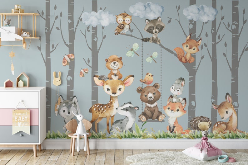 May include: A watercolor-style mural featuring a woodland scene with various animals, including a deer, bear, raccoon, owl, fox, and squirrel. The mural is set against a light blue background with gray birch trees.