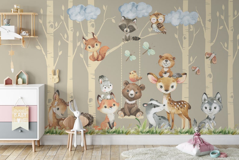 May include: A watercolor illustration of a woodland scene with a variety of animals, including a deer, a fox, a bear, a raccoon, an owl, and a squirrel. The animals are depicted in a whimsical style and are surrounded by trees and clouds. The illustration is perfect for a nursery or children's room.