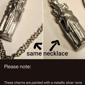 May include: A silver-tone necklace with a charm featuring a group of people. The charm is painted with a metallic silver-tone paint. The listing photos show different lighting scenarios - the light source will impact how reflective / shiny the charm appears to be, and color may vary with monitor settings.