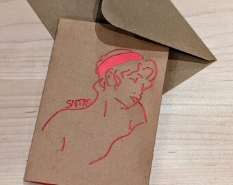 May include: A brown card with a red line drawing of a person's head and shoulders. The word "Sappho" is written on the card.