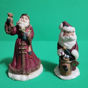 Set of 2 Mismatched Santa Claus Figurines, Both Holding Toys  **Free Shipping**