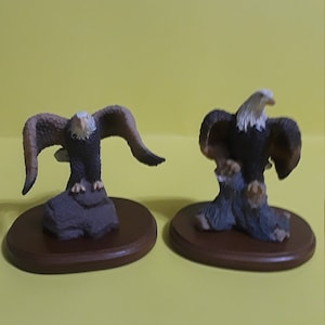Set of 2 Eagle Figurines with Wooden Bases, One Eagle Perched on a Rock w/ Wings Spread out, the Other is on a Branch w/ Wings Spread Out