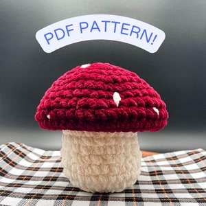 May include: Crochet mushroom amigurumi pattern, featuring a red cap with white dots and a white stem. The pattern is available as a PDF download.