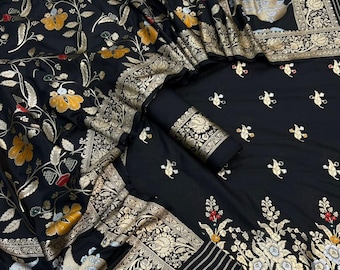 May include: A black fabric set featuring intricate gold and silver metallic floral embroidery. The design includes large yellow and red flower motifs, detailed leaf patterns, and a wide decorative border with striped and ornate botanical elements.