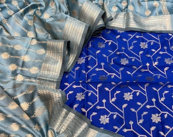 May include: A two-toned fabric piece featuring a light blue section with a repeating gold floral pattern and a vibrant royal blue section with a gold branching vine and flower motif. Both sections include wide, intricate gold metallic borders.