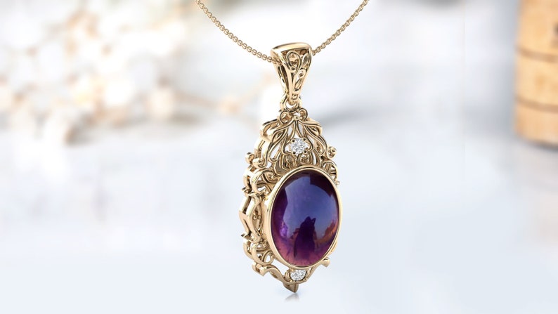 May include: A gold pendant necklace with an oval amethyst gemstone surrounded by a filigree design and small diamonds.