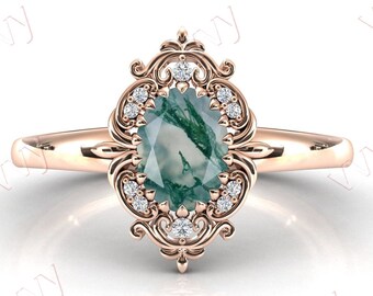 May include: A rose gold ring with a green agate gemstone set in a filigree design with small diamonds.