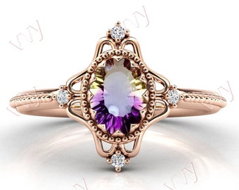 Puede incluir: Un anillo de oro rosa con una gran piedra preciosa ovalada que tiene un degradado de verde, amarillo y morado. El anillo tiene un delicado diseño de filigrana y está adornado con pequeños diamantes.