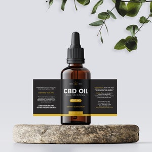May include: A black and gold label on a brown glass bottle of CBD oil. The label reads "CBD Oil Full Spectrum 1000 mg Dietary Supplement".