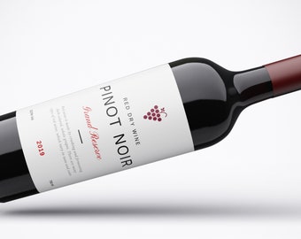 May include: A bottle of red dry wine labeled "Pinot Noir Grand Reserve" with a bunch of grapes on the label. The bottle is 750 ml and the vintage is 2019.