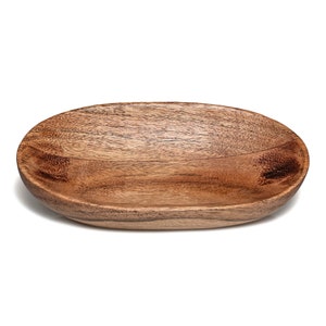 May include: A wooden oval serving bowl with a natural wood finish. The bowl is made of acacia wood and has a smooth, polished surface.
