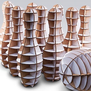 May include: A set of ten wooden bowling pins and a bowling ball, all made of cardboard and designed with a geometric pattern. The pins and ball are white with brown accents.