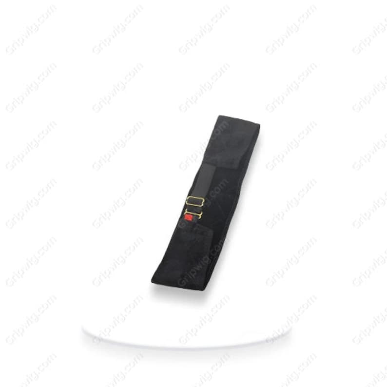 May include: Black back support belt with a red and gold buckle. The belt is made of a soft, flexible material and has a contoured shape to fit the natural curve of the back.