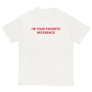 May include: White t-shirt with the text "I'M YOUR FAVORITE REFERENCE" printed in red.