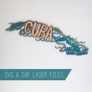 May include: A wooden map of Cuba with the country's name and city names in a light brown color. The map is layered over a teal blue outline, with the text "SVG & DXF LASER FILES" in a teal banner.