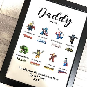 May include: Framed print with the word "Daddy" and superhero comparisons: Thor, Captain America, Spiderman, Batman, Hulk, Wolverine, Iron Man, and Superman. Includes space for personalization.