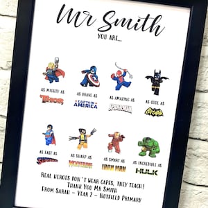Peut inclure: Impression encadrée avec bordure noire. L'impression présente le texte "Mr Smith, YOU ARE..." avec des illustrations de super-héros et des phrases comme "As Mighty As Thor" et "Real heroes don't wear capes, they teach!"