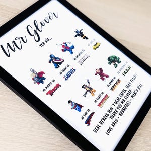 May include: Framed print with a black border featuring superhero illustrations and text. The print reads "Mr. Glover, You Are..." followed by superhero comparisons like "As Mighty As Thor" and "As Brave As Captain America."