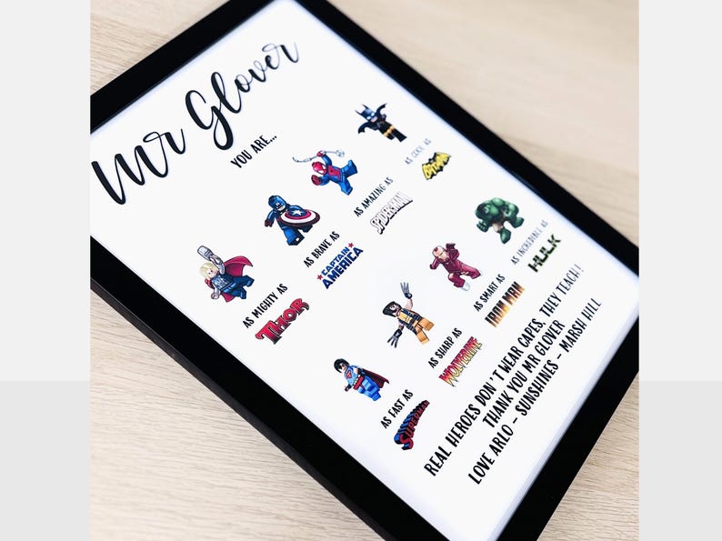 May include: Framed print with a black border featuring superhero illustrations and text. The print reads "Mr. Glover, You Are..." followed by superhero comparisons like "As Mighty As Thor" and "As Brave As Captain America."