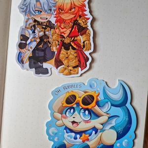 May include: Set of three stickers featuring anime-style characters. Two stickers depict male figures in detailed armor and clothing. The third sticker shows a blue and white creature with sunglasses and the text "OH BUBBLES MY BUBBLES."