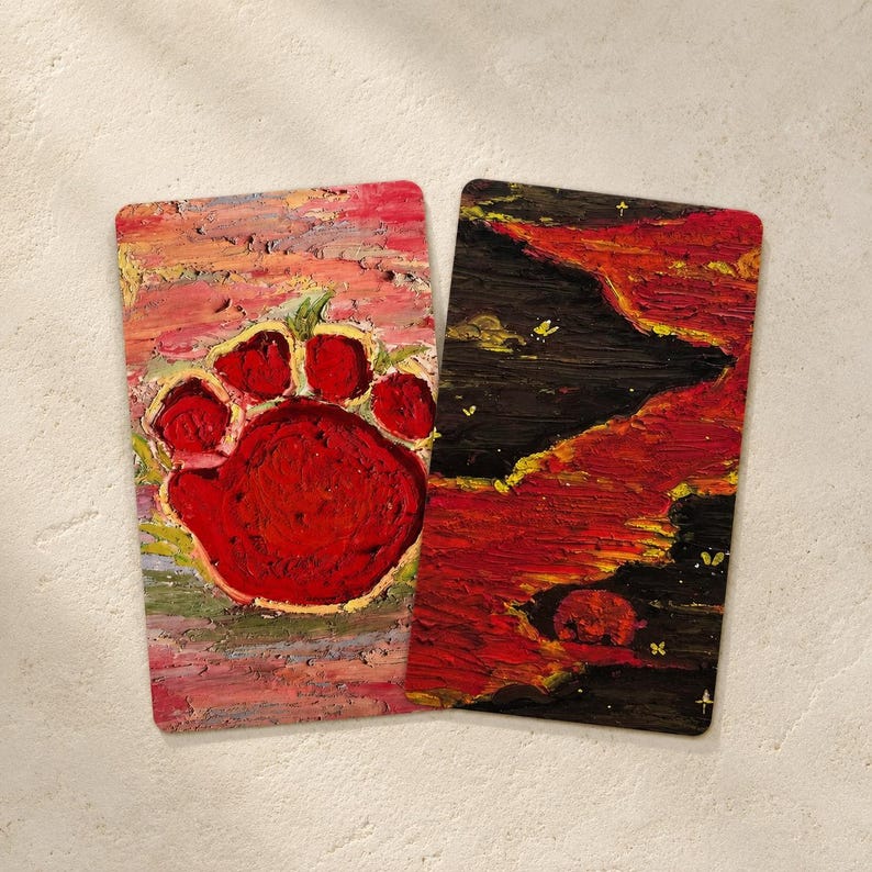 May include: Two rectangular, textured art pieces. One features a large red paw print on a pink and yellow background. The other has a dark, fiery landscape with red and yellow hues, and small white accents.