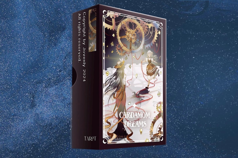 May include: A box of Cardamom Dreams Tarot cards featuring a colorful illustration of two women in a whimsical setting with gears and a red string connecting them. The box is black with gold lettering and the text "Copyright by Jovenly 2024 All rights reserved" on the side.