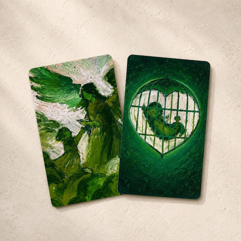 May include: Two rectangular art prints with green and white abstract paintings. One depicts a figure with a child, the other a heart-shaped cage with a figure inside. The prints are on a neutral background.