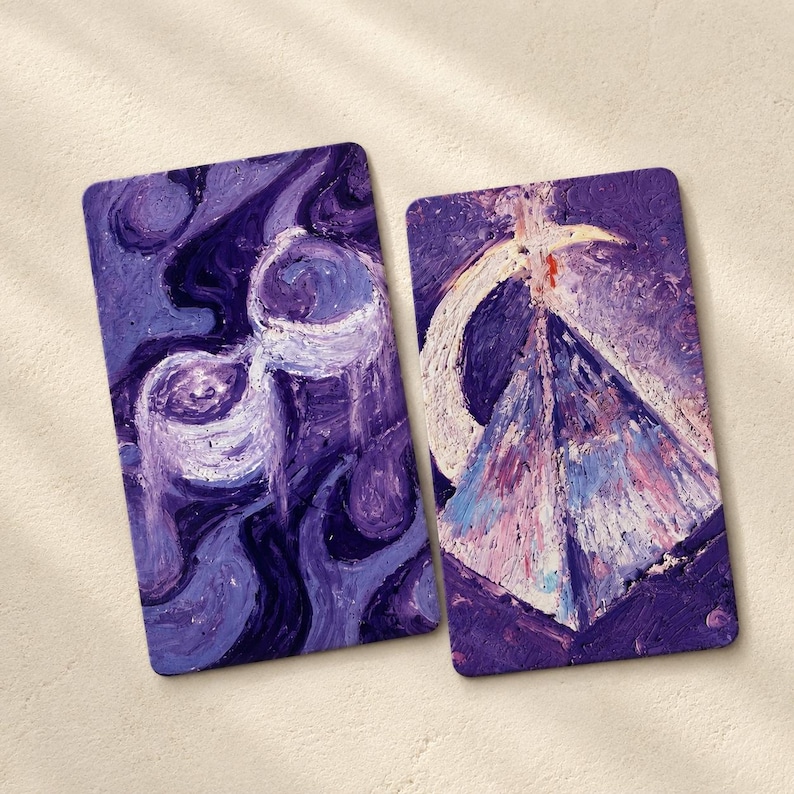 May include: Two rectangular art prints with rounded corners. One features a swirling, abstract design in shades of purple and white. The other depicts a pyramid with a crescent moon and a cross, in purple, white, pink, and blue.