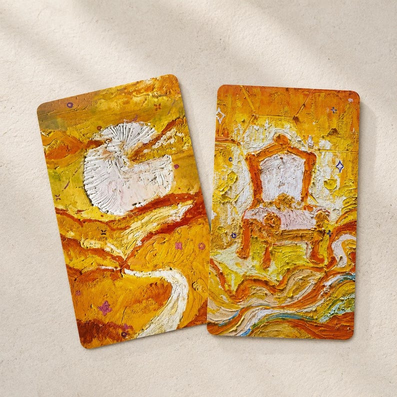 May include: Two rectangular art prints with a textured, impasto style. One features a white, cloud-like shape against a yellow and orange background. The other depicts a white chair with an orange frame, set against a similar backdrop.
