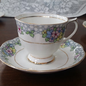 Royal Albert Crown China Tea cup & saucer, Beautiful stylized poppies in pastel pink, blue, and green. Pattern 2132