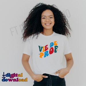 May include: White t-shirt with the text "VIE DE PROF" in colorful, retro-style lettering.
