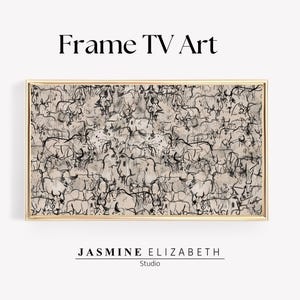 May include: A framed abstract art print with a black and white design of animals on a beige background. The frame is gold.