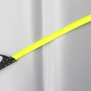 May include: A black and yellow katana sword with a futuristic design. The blade is made of bright yellow plastic and the handle is black with a textured grip.