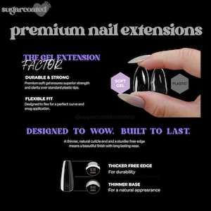 a woman's hand holding a black and white nail
