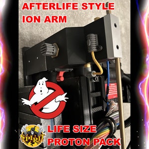 May include: A black and gray Ghostbusters proton pack with a red switch and a black and white no ghost symbol. The pack is labeled "Afterlife Style Ion Arm" and "Life Size Proton Pack".