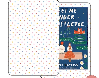 May include: A digital book cover with a blue background and a colorful illustration of a couple sitting on a bench under a mistletoe. The text on the cover reads "Meet Me Under the Mistletoe" and "Jenny Bayliss". The Twelve Dates of Christmas.